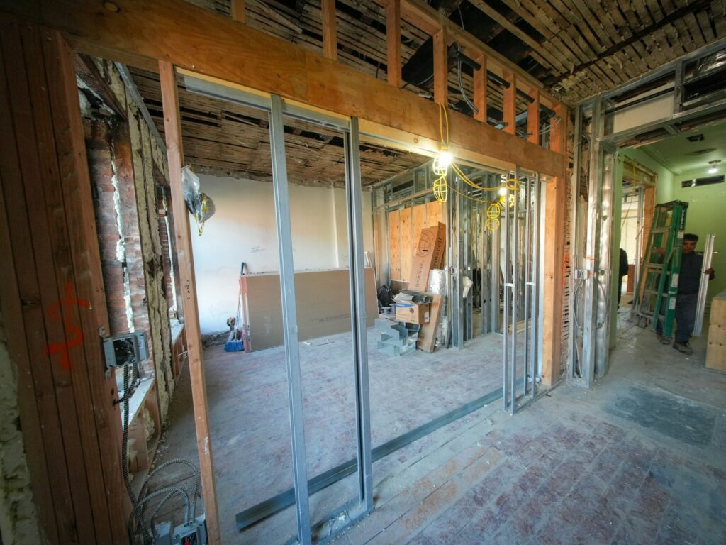Three-story brownstone in mid-renovation, the kind of pre-1989 housing where homeowners commonly test for asbestos.